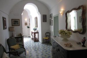 a room with a vanity with a mirror and a chair at Domus Claudia in Atrani