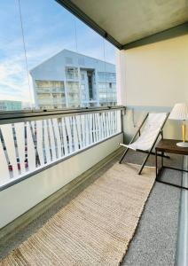a balcony with a chair and a table and a window at Modern family apartment next to metro easy access to Helsinki in Espoo