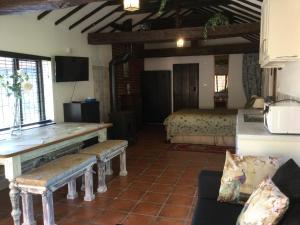 a living room with a couch and a bed in a room at The Garth Guest Suite Studio Cottage in Lingfield