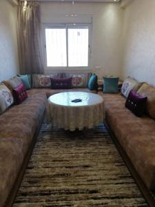 a living room with a couch and a table at شقة بمراكش in Marrakesh