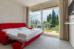 A bed or beds in a room at La Chioma di Berenice Garda Residence