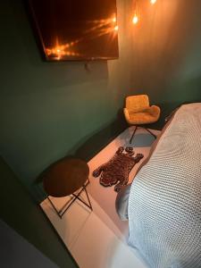 a room with a bed and a stool and a chair at NEOZONE Neostudio Malmedy in Malmedy