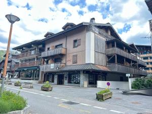 a large building with balconies on the side of a street at Appartement Centre Les Gets - Balcon, 6 Couchages, Proche Remontées, Animaux Acceptés - FR-1-623-217 in Les Gets +3 photos