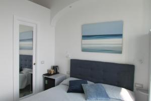 1 dormitorio con 1 cama y una foto en la pared en Domus Claudia en Atrani