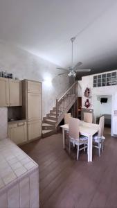 a kitchen with a table and chairs and a staircase at Mare fuori in Bari