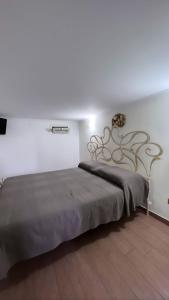 a bedroom with a large bed in a white room at Mare fuori in Bari