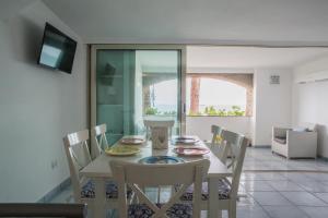 a dining room with a table and chairs at Luxurious apartment by the sea in Vietri sul Mare
