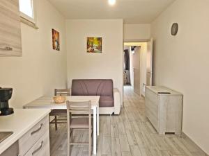 uma cozinha e sala de estar com uma mesa e uma cadeira em Civico 14 Apartment 2 em Monserrato