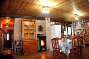 a kitchen with a table and a fireplace in a room at El Descanso del Talegones in Torrevicente