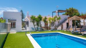 a swimming pool in the backyard of a house at Villa Tablazos 29 Nerja by Ruralidays in Frigiliana