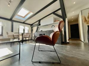 a living room with a chair and a table at Bielawy Suite in Bydgoszcz