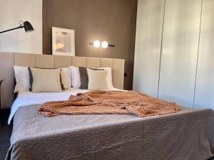 a bedroom with a large bed with a blanket on it at Bielawy Suite in Bydgoszcz