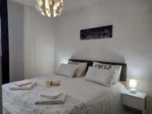a bedroom with a bed with two towels on it at Apartman Zara in Zadar