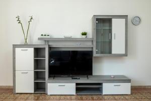a entertainment center with a tv and a mirror at Le Case di Franca in Trapani
