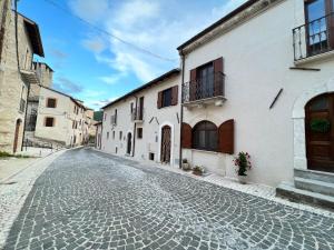 eine Kopfsteinpflasterstraße in einer Stadt mit weißen Gebäuden in der Unterkunft Casa Michela in Caporciano