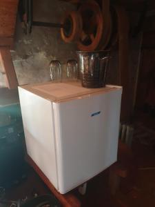 a white refrigerator with two glasses on top of it at Moulin de la Bretonnière - Omaha Beach Dday in Aignerville