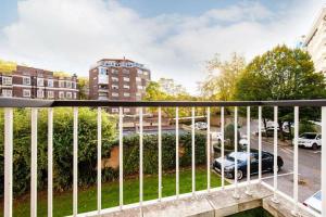 a balcony with a fence and a parking lot at Ultra Luxury Central London 3Bed Apartment in London