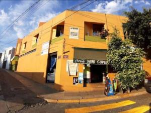 a yellow building on the side of a street at Encantadora casa tradicional con terraza in Oaxaca City