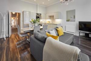 a living room with a couch and a dining room at Host & Stay - Brooklands Timeless in Scarborough