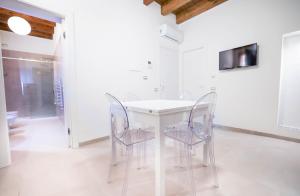 a dining room with a white table and chairs at Case Ruggieri Apartments - Don Leonardo in Gratteri