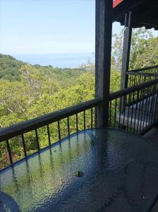 een tafel op een balkon met uitzicht op de oceaan bij STUDIOS CHRISTINA in Póroi