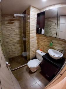a bathroom with a toilet and a sink and a shower at Cómodo apartamento tipo Loft en centro de Bogotá 5 in Bogotá