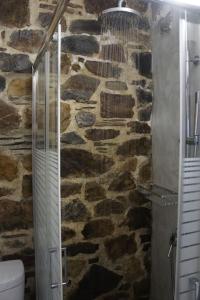 a stone bathroom with a shower and a toilet at Rosales stone house in AmigdhalokeFálion