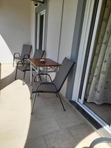 two chairs and a table on a balcony at ARTEMIS Studios & Apartments Sidari in Sidari