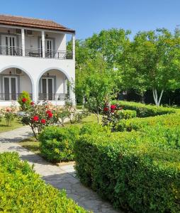 a house with a garden in front of it at ARTEMIS Studios & Apartments Sidari in Sidari
