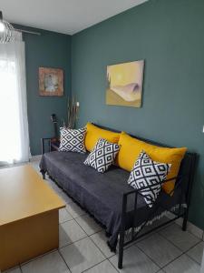 a living room with a couch with pillows on it at villa Narkissos - Καναλάκι - Εξοχική κατοικία in Nárkissos