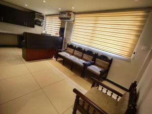 a waiting room with benches and a large window at IVY RESIDENCY in Trivandrum