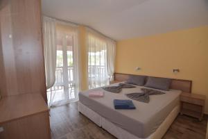 a bedroom with a bed and a large window at Villa Raya in Sozopol +66 photos