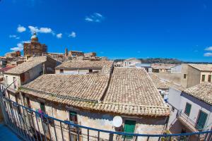 an old building with tile roofs in a city at Umberto 33 in Piazza Armerina