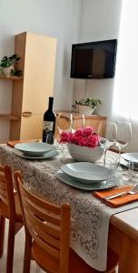 a table with two plates and a bottle of wine at Il Blu di Laveno in Laveno