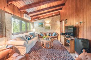 a living room with a couch and a table at Fun in the sun classic villa at Los Lagos in Casa de Campo in Las Minas