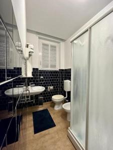 a bathroom with a toilet and a sink and a shower at Il Blu di Laveno in Laveno