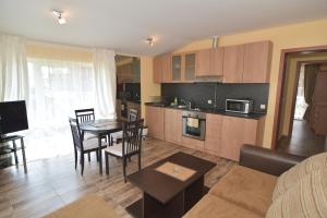 a kitchen and living room with a table and chairs at Villa Raya in Sozopol