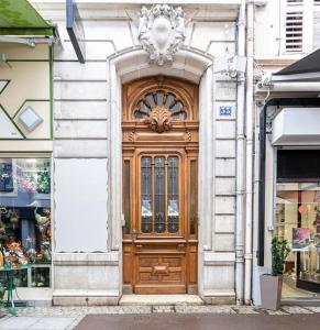 a large wooden door on the side of a building at L'Exception, sérénité et confort, Evian centre in Évian-les-Bains
