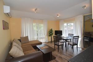 a living room with a couch and a table at Villa Raya in Sozopol