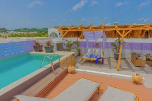a villa with a swimming pool and a deck at City Compass Luxury Villa in Faliraki