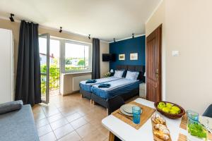 a bedroom with a bed and a table in a room at Przystań Nemo in Ustka