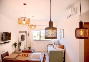 a living room with pendant lights and a table at ALQUILERES TEMPORARIOS MADRYN in Puerto Madryn