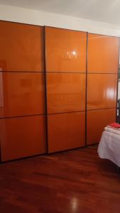 a closet with orange dividers in a room at Montagnola House in Rome