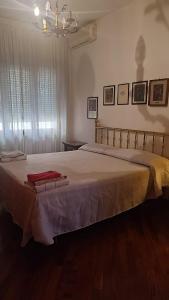 a bedroom with a large bed with two towels on it at Montagnola House in Rome