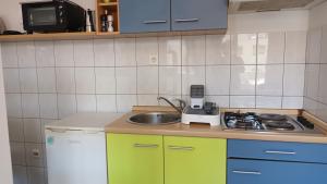 a small kitchen with a sink and a stove at Cozy apartman Aurelio in Split