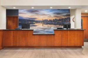 a lobby with a large wall mural of a harbor at The INN at Gig Harbor in Gig Harbor