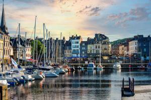 a group of boats are docked in a harbor at Les Maisons de Lea, a member of Radisson Individuals in Honfleur