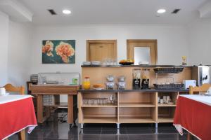 a kitchen with a counter with some food on it at Hotel Solar da Charneca in Leiria