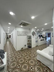 uma sala de estar com um sofá e piso em azulejo em Hostal Nova Barcelona em Barcelona