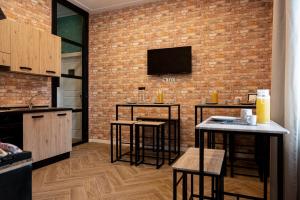 a kitchen with bar stools and a brick wall at Gravina8 - Rooms in Naples in Naples